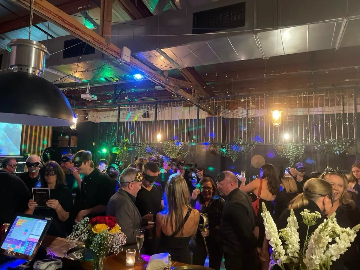 Masked guests filling the bar at a masquerade night
